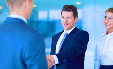 Image of two successful business men shaking hands with each other