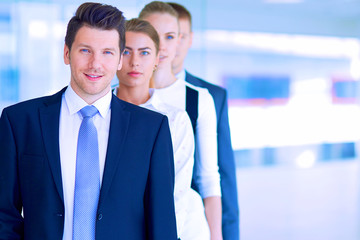 Smiling successful business team standing in office