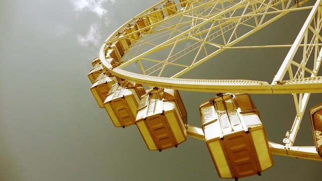 Retro Ferris Wheel Amusement park - Panoramic shot 60fps. The Fete foraine du Jardin des Tuileries is a small amusement park that is set up every summer in the Tuileries Gardens