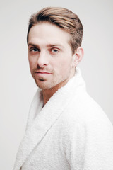 Emotions. Portrait of a young man in a bathrobe