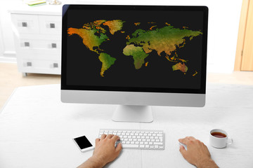 Human working with pc, with world map and network on screen