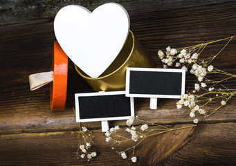 White Wooden Heart In Gift Box, Small Blackboards And White Dried Flowers On Wooden Boards. Romantic Composition.