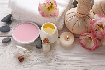 Spa composition and treatments on light wooden background, close-up