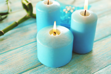 Fototapeta na wymiar Blue candles with spa salt and bamboo on table