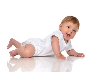 Infant child baby girl in diaper lying happy smiling looking at