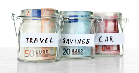 Three jars for different needs full of coins