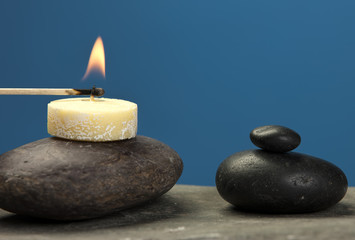 Fototapeta na wymiar Lighting a small candle on rock.