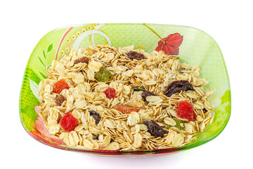 Cereal muesli or oat flakes with dried fruit on plate, isolated on white background