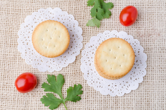Top view of crackers biscuits on burlap sack background