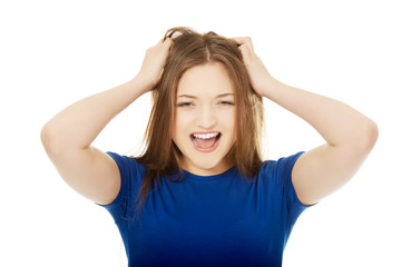 Fototapeta premium Frustrated young woman screaming.