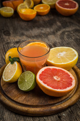 Citrus juice and fruits on vintage background
