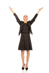 Young happy business woman with arms up