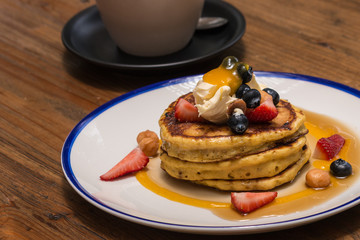 pancakes with berries and maple syrup