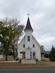 Fototapeta na wymiar Old Fashion White Church with a Steeple