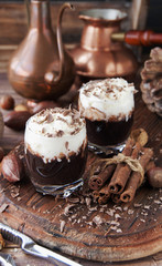 hot chocolate in glass cups and cream with nuts