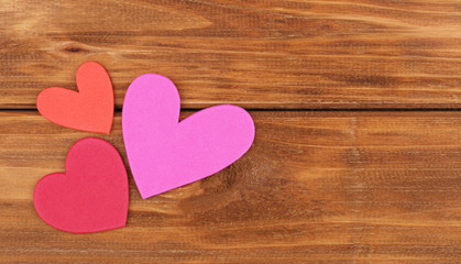 Valentine's Day background. Two paper hearts on wooden backgroun