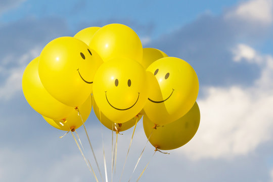Yellow balloon smile  with  sky and clouds.