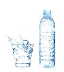 Splashing of water with ice in glass on white background.