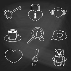 Set of love icons painted with white chalk on a blackboard. Decorative icons for Valentine's day. Hands-drawn style