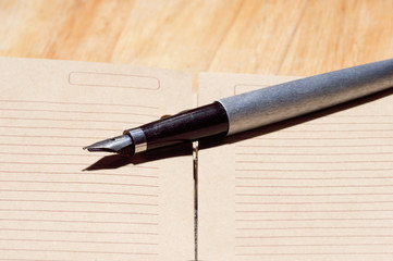 Old fountain pen on a notebook