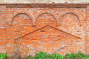 Ancient cut away brick wall with decorative arches and rhomb of Transfiguration monastery based on 1525 in Belyev city. Tulsky region, Russia. 
