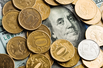 russian roubles coins on banknotes of dollars