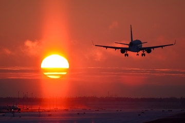 Airplane landing to sunset