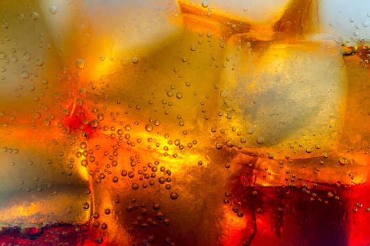 Cola ice cubes bubbles macro close up