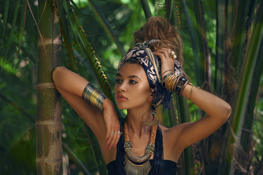 Fashion model posing outdoors with jungle background