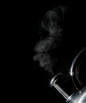 kettle whistling, boiling kettle, steam, isolated on a black background