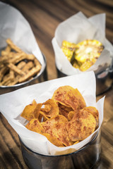 rustic potato chips and other snack food on table