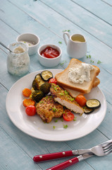 Spicy chicken breast on a white plate with grilled vegetables