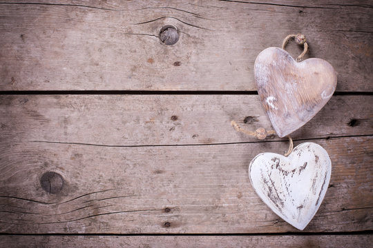 Two  rustic decorative  hearts on vintage wooden background