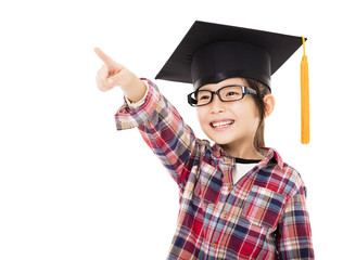 happy school kid in graduation cap with pointing gesture