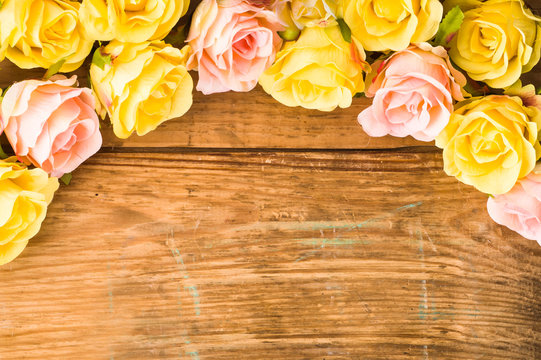 Roses flowers on wood, floral background on a vintage wooden planks useful as greeting card