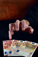 Stingy hand reaches for euro money
