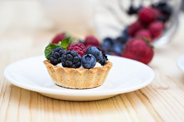 Tart  with Fresh berries - dessert on wooden table close up