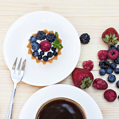 Tart  with Fresh berries - dessert on wooden table close up