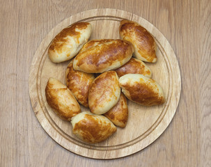 Baked russian patties on a wooden background