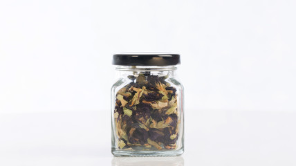 Tea pea flowers in a bottle  on white blackground