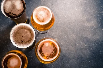Rolgordijnen Bier Beer glasses on dark table