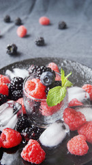 black berries and raspberries in a glass cup