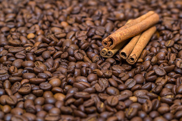 coffee beans and cinnamon on the table the whole texture of coarse brown lot