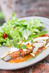 Thai food style : Fried fish toppted with chilli sauce.