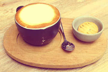 The coffee set; cup of coffee, spoon, cookies in vintage tone, like instagram filter effect