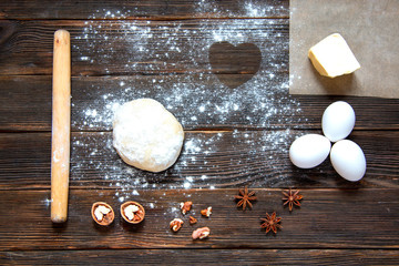 fresh dough ready for baking on rustic wooden background.