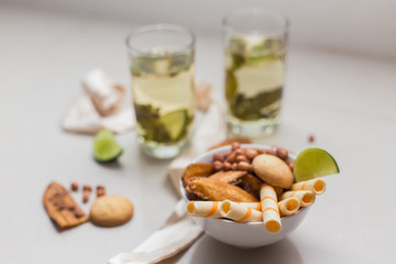Green tea in a glass with lime and cookies on a plate
