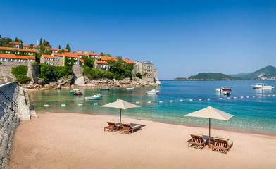 Adriatic sea luxury sand beach with chaise-longue chairs and umbrellas