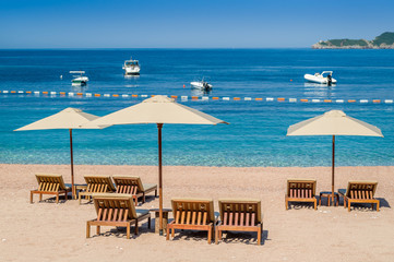 Sand beach with wooden furniture and perfect Adriatic sea