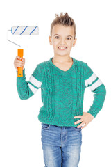 adorable young happy boy holding a paint roller on white studio